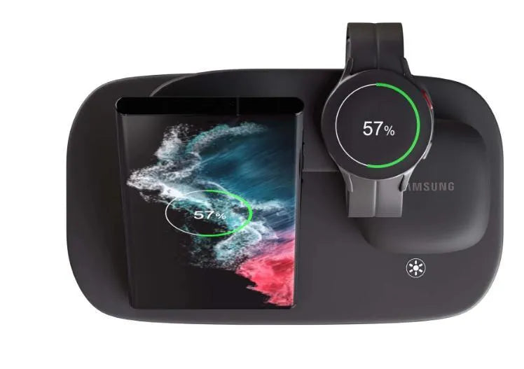Vertical 3-in-1 wireless charging stand for mobile phone, smartwatch, and headphones on a desk.