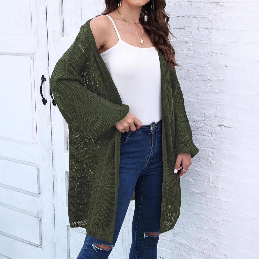 A women's loose-fitting solid colour acrylic sweater coat on a hanger.