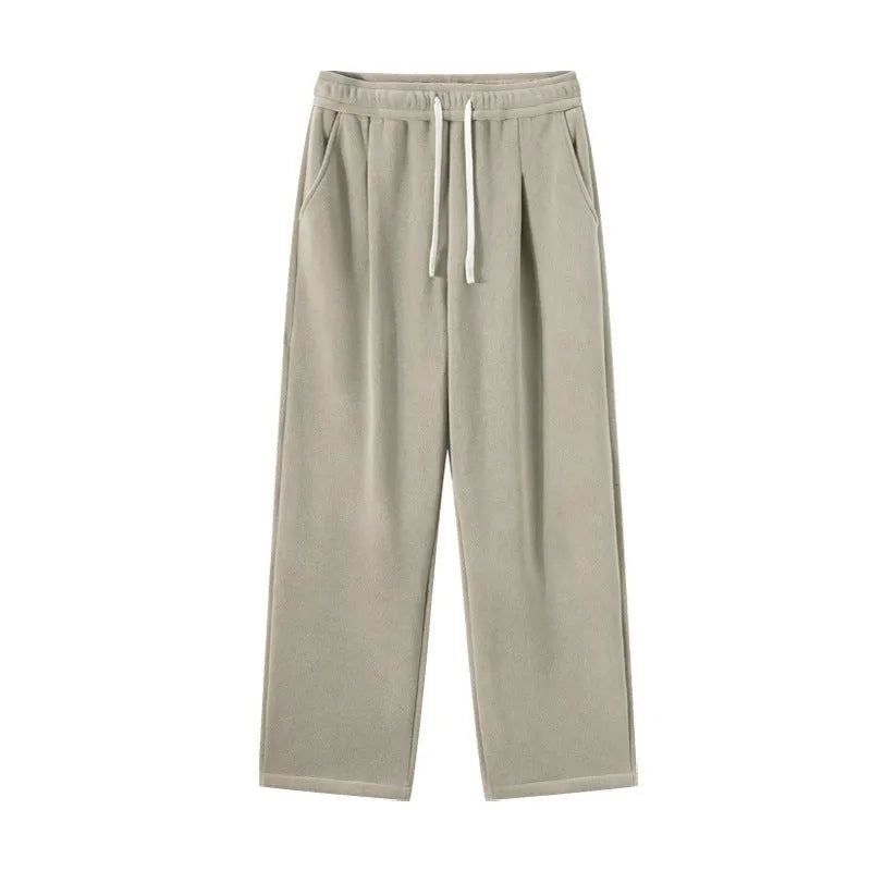 Man wearing apricot coloured loose-fit polar fleece winter sports pants with a drawstring waist.