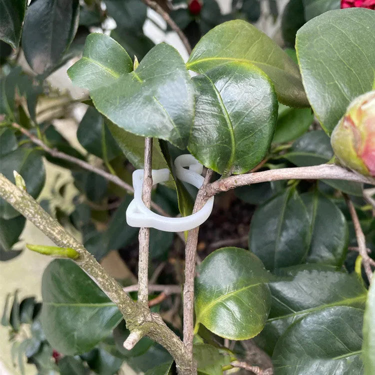 Colourful cat-shaped plastic plant clip for stem support in gardening.