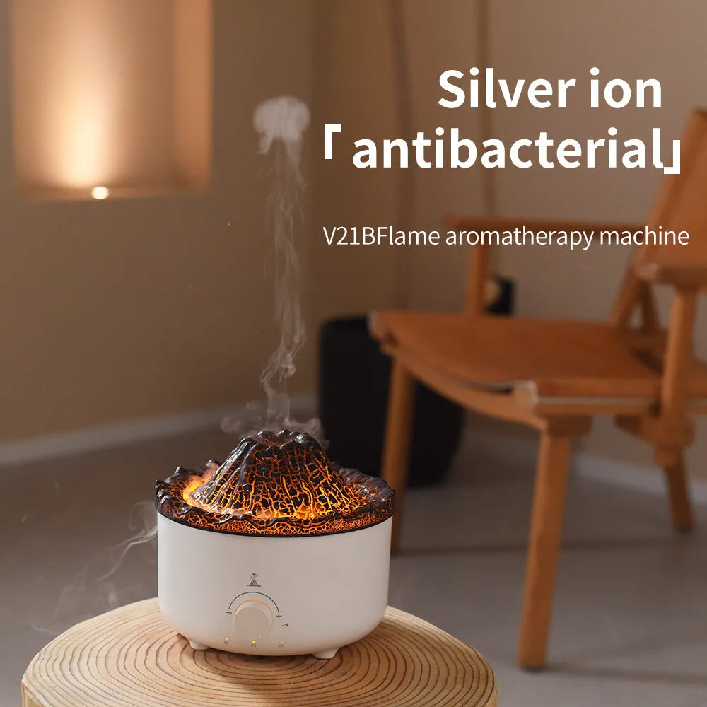 Small white volcano-shaped humidifier with simulated flame lighting and remote control on wooden table