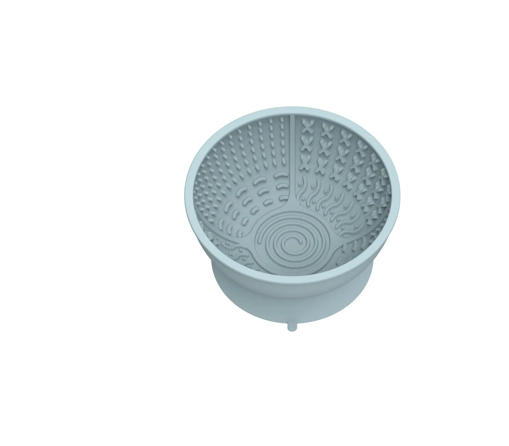 Cyan silicone pet licking mat bowl with suction cup base and textured feeding surface.