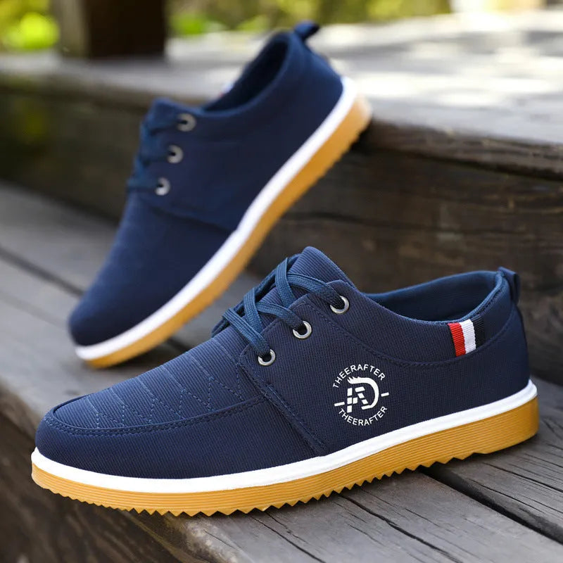 Men's black canvas casual work shoes with a non-slip sole and leather toe cap on a white background.