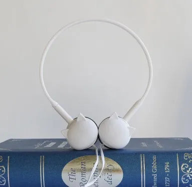 Cute cat stereo earphones with cat ear design in a choice of colours on a plain background
