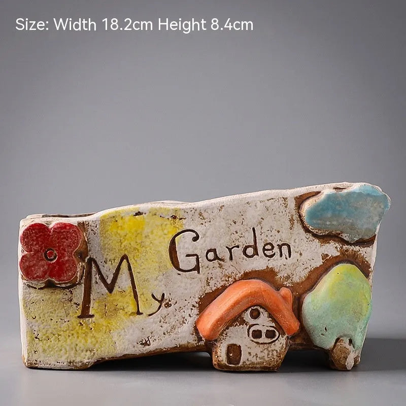 Large calibre ceramic flower pot with hand-painted cute pastoral design on a white background.