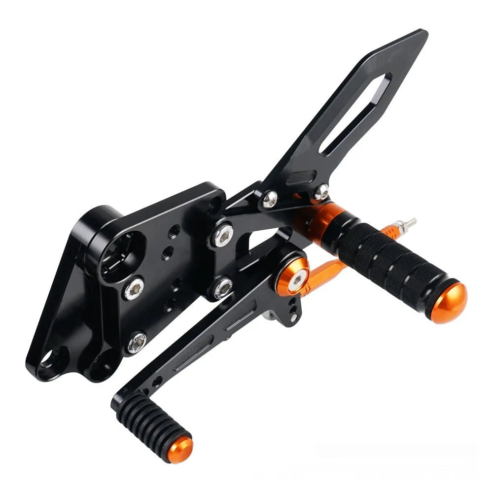 Black and orange KTM Duke motorcycle raised footrest bracket assembly