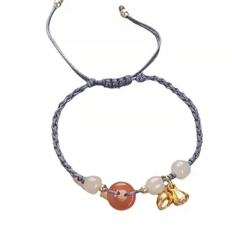 Hetian jade peace buckle bracelet on a brown strap, showing constellation detail.