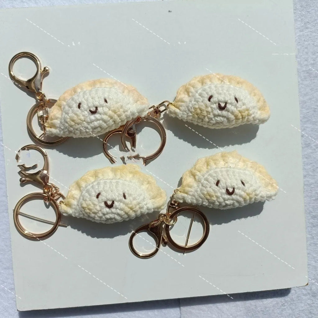 Handmade crochet dumpling pendant with keychain in plush material showing hand-stitched eye details