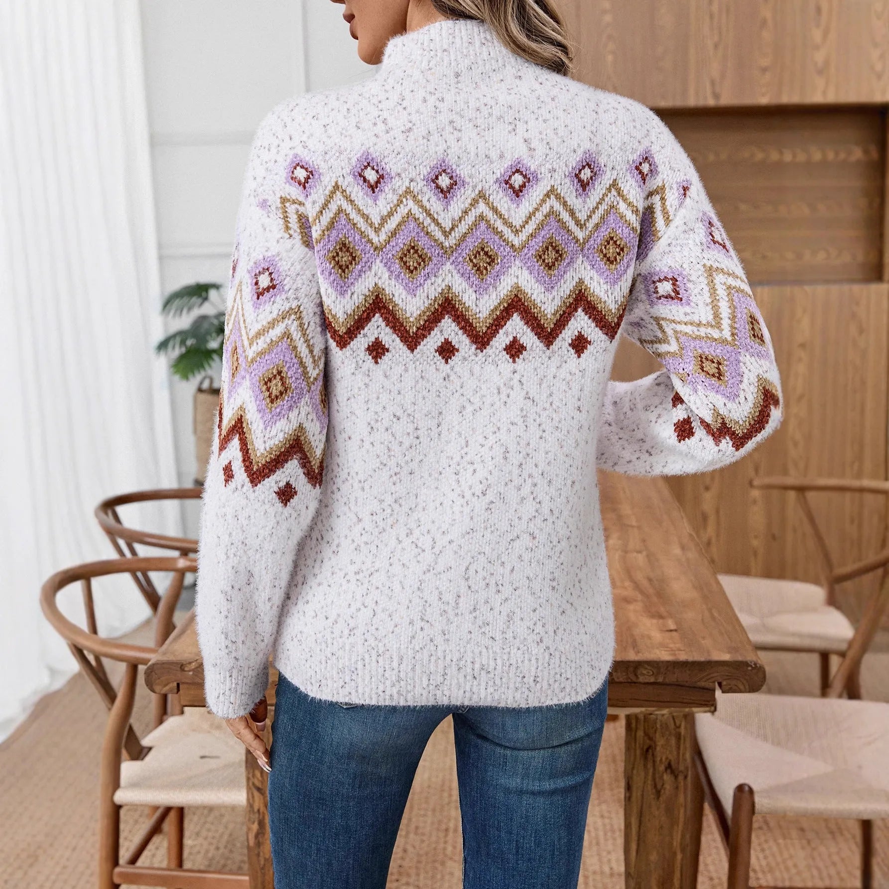 White loose half turtleneck sweater with geometric jacquard pattern and long sleeves.