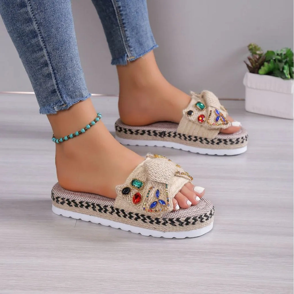 Creamy-white women's platform sandals with a cloth upper, beach bow detail, and slip-on sleeve design.