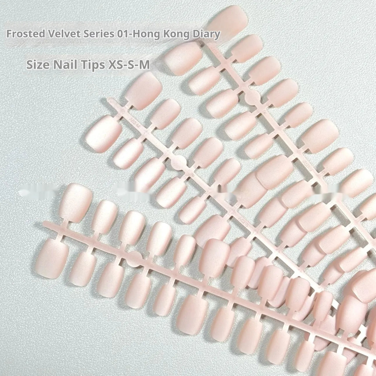 Frosted velvet Cat's Eye artificial nail set with Aurora shine on a short ladder PVC nail.