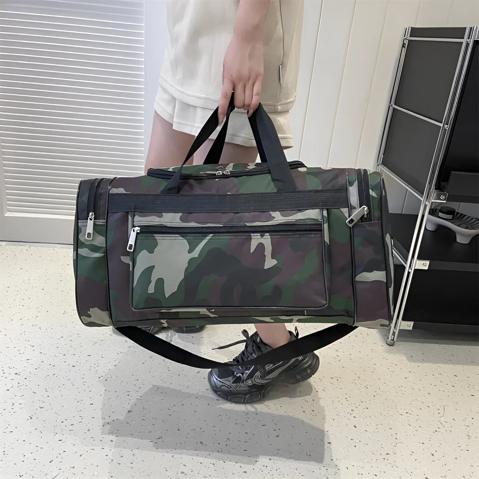 Large camouflage-coloured luggage bag made from waterproof fabric with striped lining.