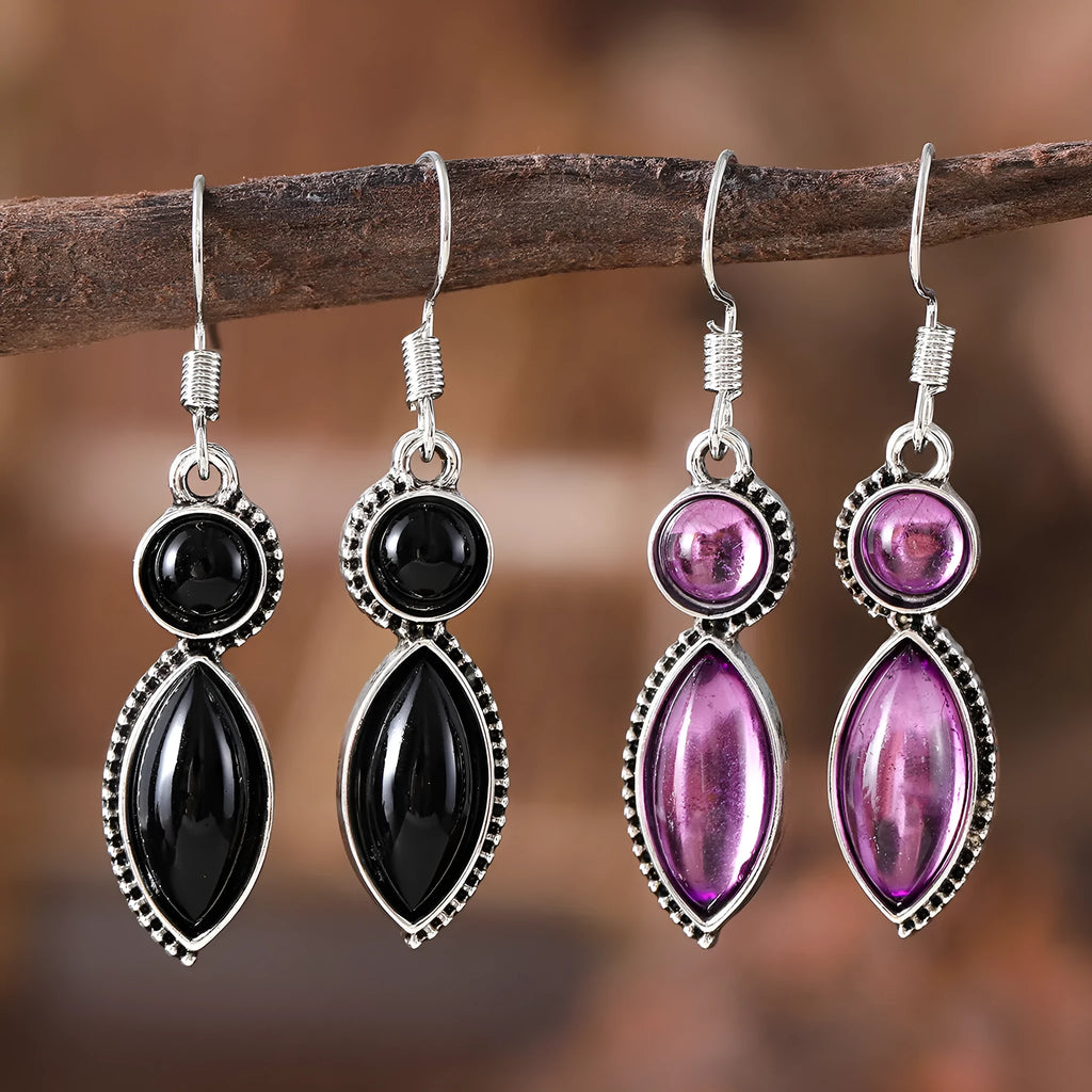 A pair of vintage-style geometric drop earrings in black and purple with a round element, bohemian jewellery.