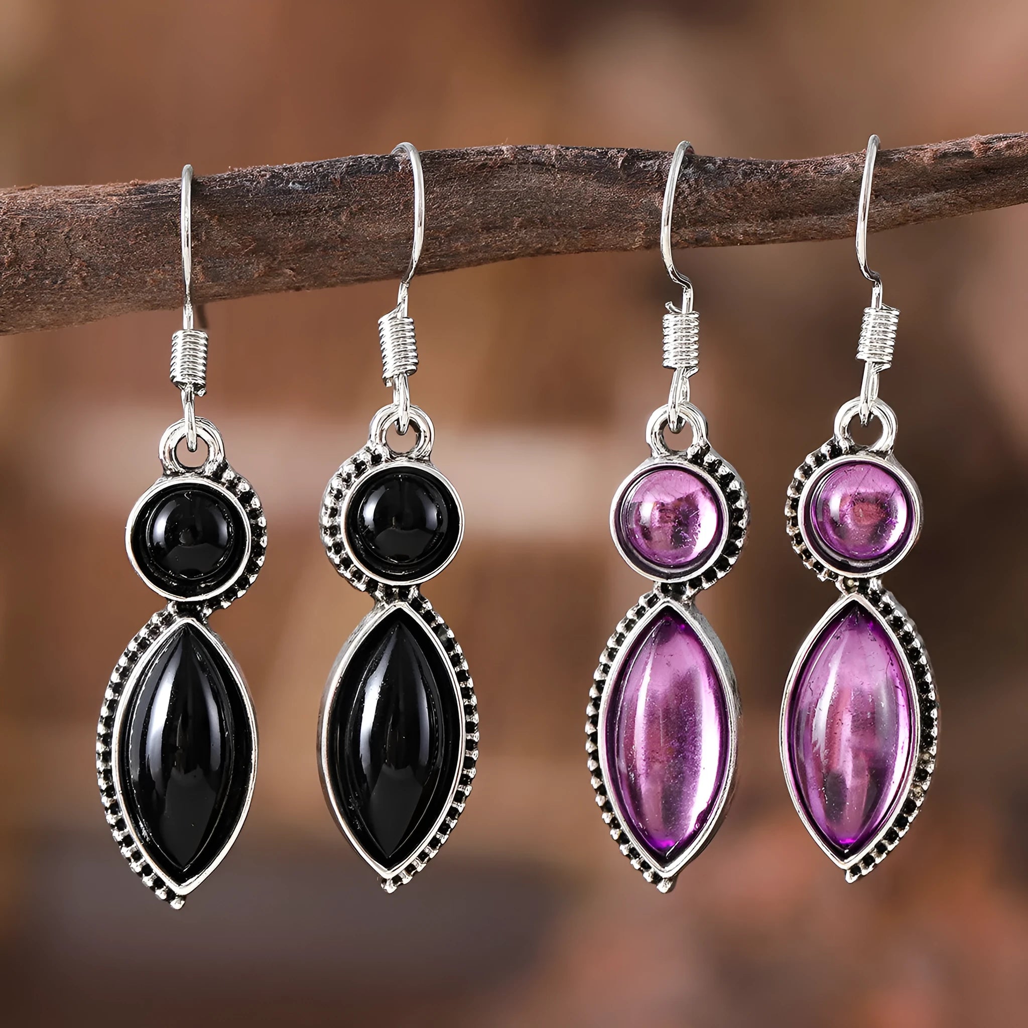 A pair of vintage-style geometric drop earrings in black and purple with a round element, bohemian jewellery.