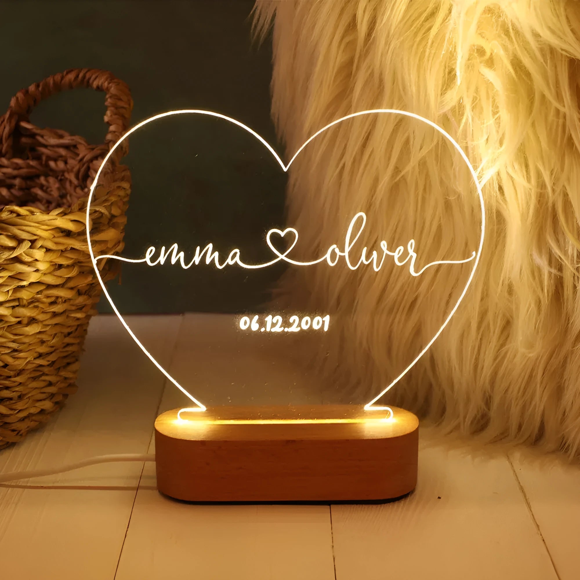 Custom transparent acrylic night light showing personalised names and date, lit by an LED base.