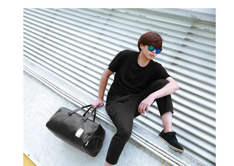 Black waterproof sports duffel bag with two side shoe compartments and diagonal straps, shown in large and small sizes.