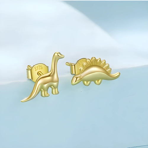 Asymmetric dinosaur stud earrings in 925 silver, animal element design, gold or silver colour option, on a neutral background
