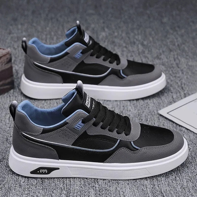 Men's low-top canvas trainers in black, beige, and grey with mesh lining and leather stitching.