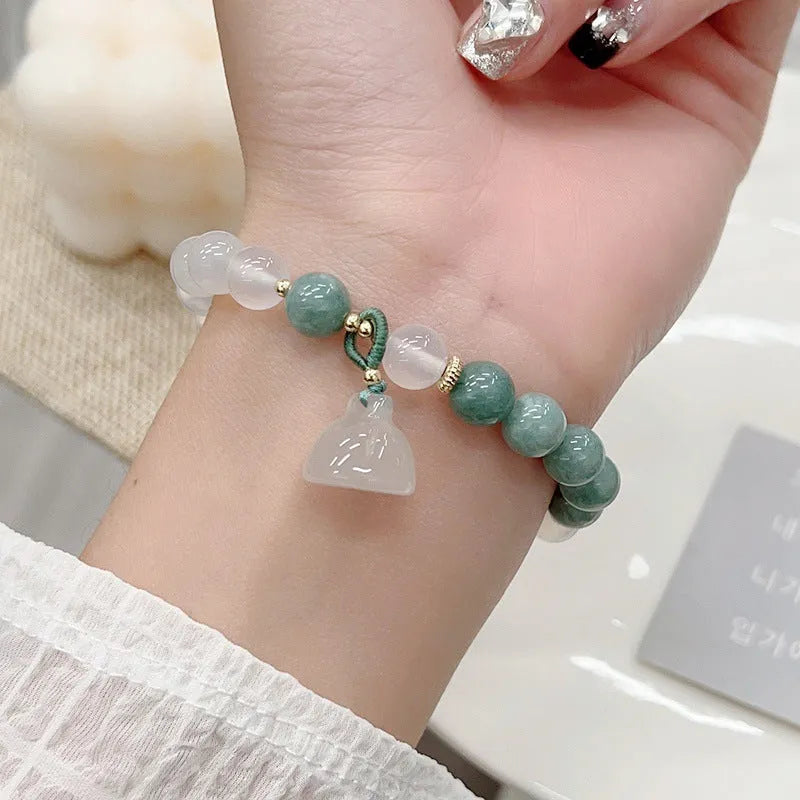Close-up of a women's retro Chinese style agate lotus seedpod bracelet on an adjustable strap.