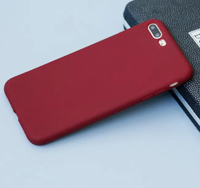 Frosted matte soft phone case for Apple iPhone models on a table.
