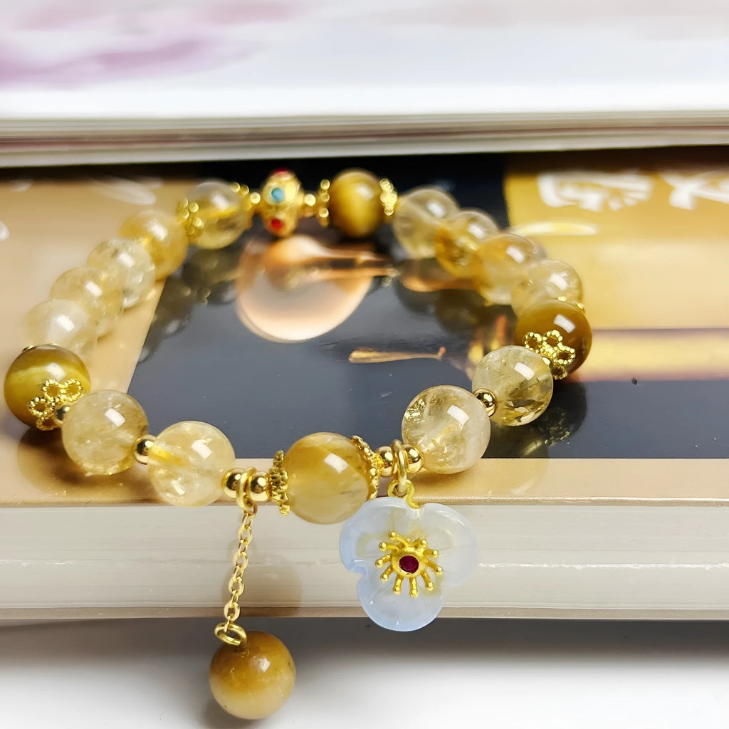 Handmade citrine colour crystal bracelet with floral and tassel detailing for women.