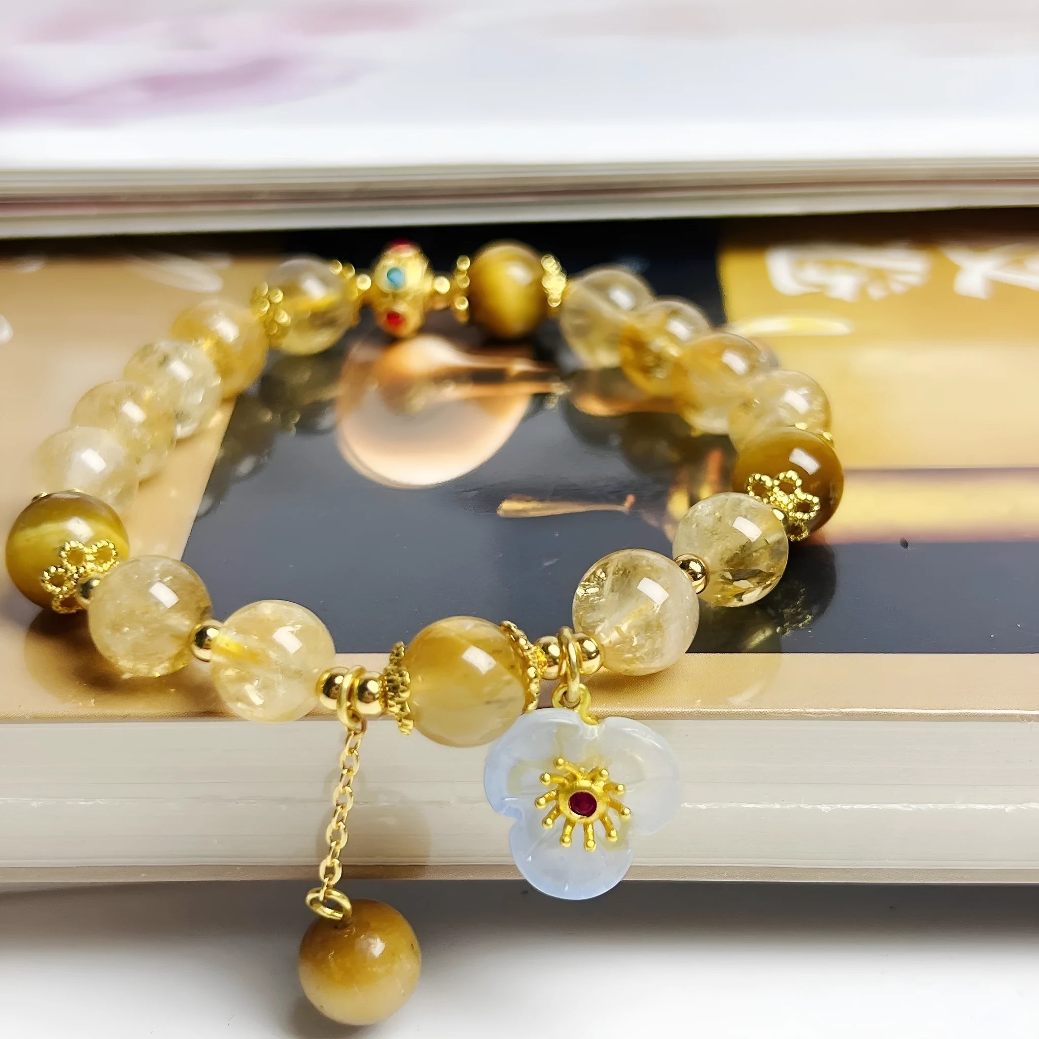 Handmade citrine colour crystal bracelet with floral and tassel detailing for women.