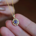 Golden royal necklace with mixed gemstone pendant on a box chain, adjustable length.