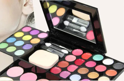 Three-layer makeup box with 24 colour eyeshadows, 8 lipsticks, blushes, powders, brushes, and mirror