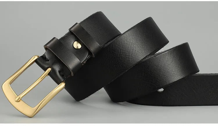 Handmade casual men's cowhide belt with needle buckle and leather decoration, black colour, on a plain background