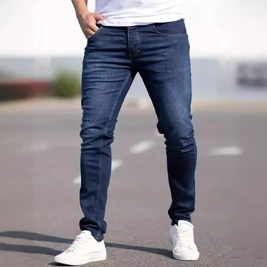 Men's dark blue slim fit casual jeans with a mid-waist and skinny leg style.