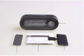 Black digital LED car clock and thermometer with adjustable mounting bracket on a dashboard.