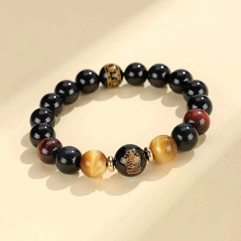 Manually crafted black agate beaded bracelet with gold, blue, and red tiger eye stones, showing ethnic zodiac design.