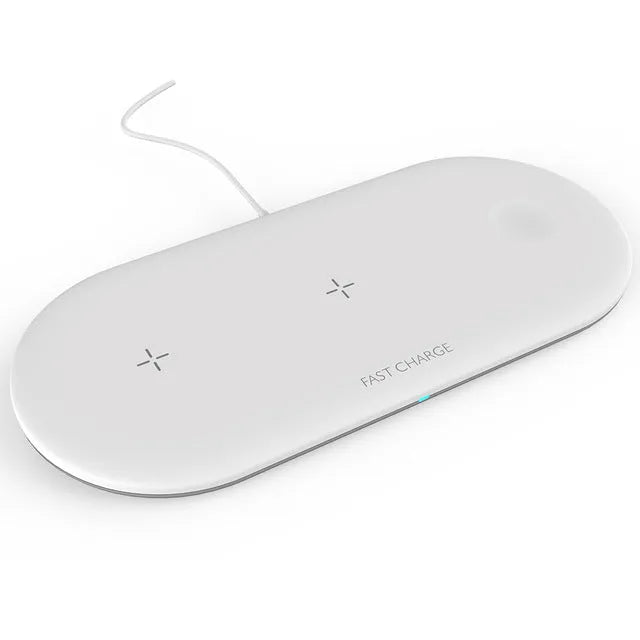 White three-in-one wireless charging station for Apple iPhone, watch, and headphones on a desk.