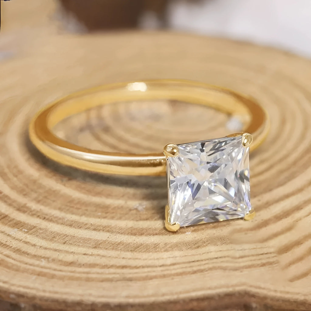 A 925 sterling silver ring with a single round cubic zirconia stone on a geometric band.