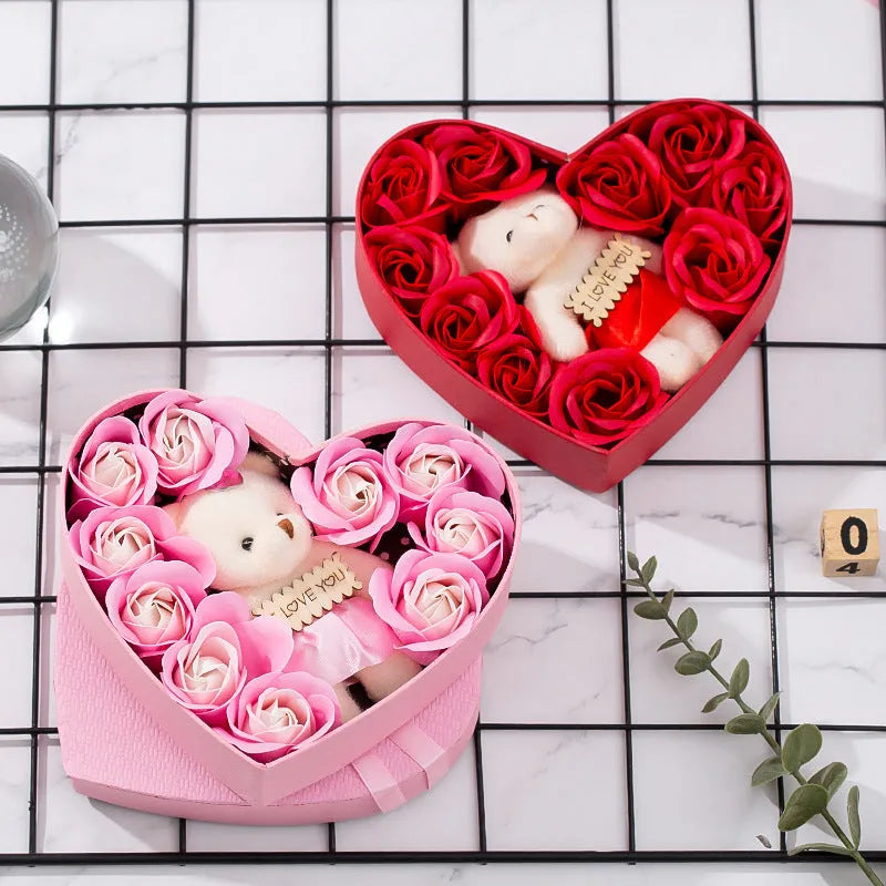 Red heart-shaped gift box open to show pink and red soap roses inside
