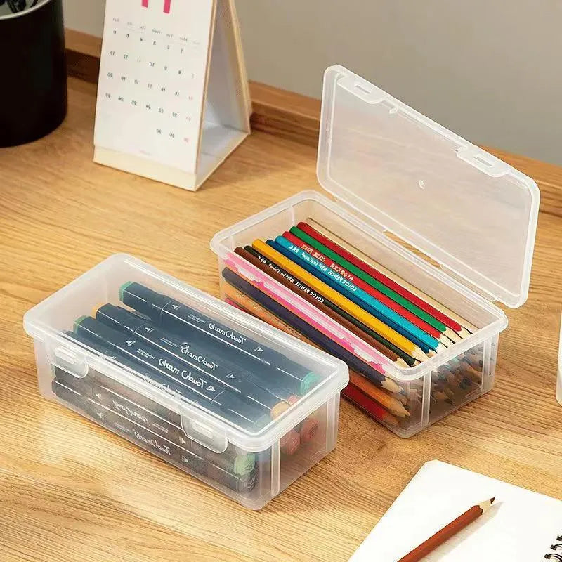 Transparent plastic pencil storage box showing organised drawing tools inside