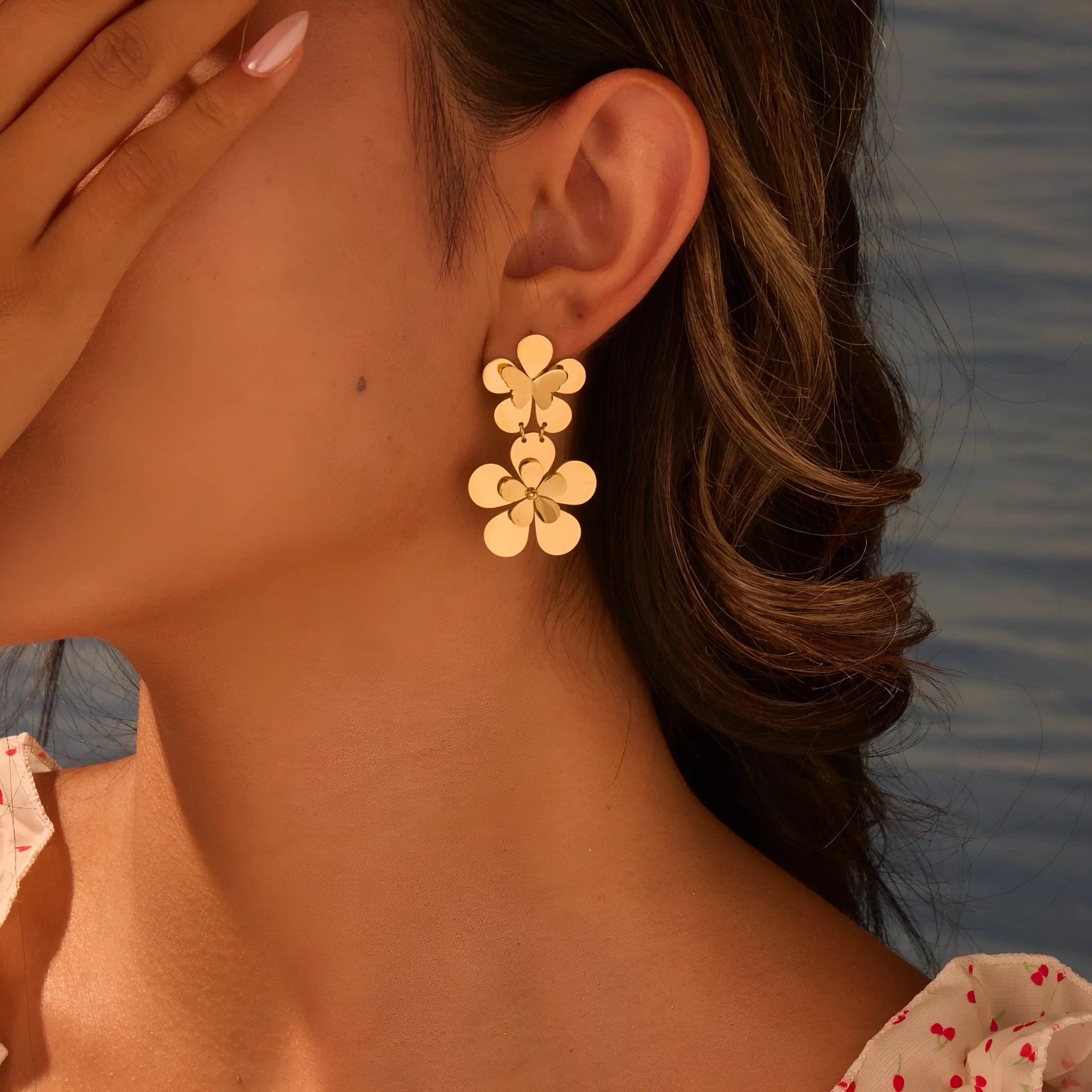 Gold flower butterfly earrings for women with geometric design on stainless steel.