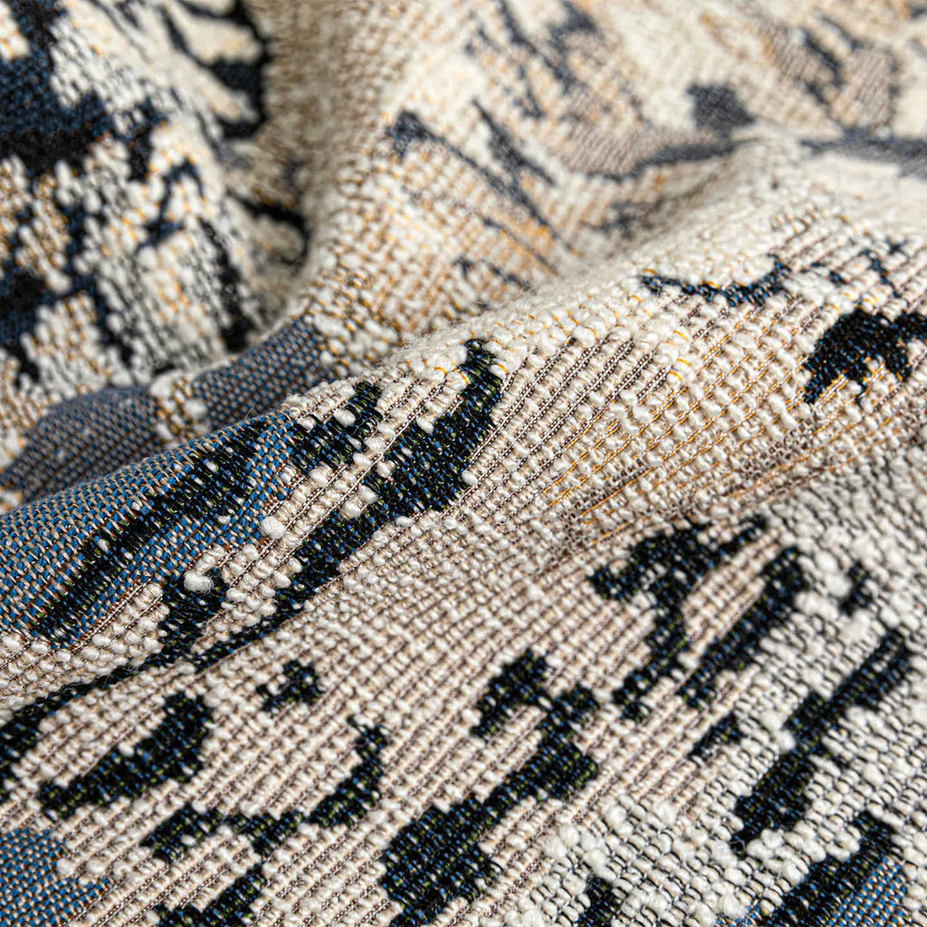 Chinese style antique blue floral pattern decorative cushion with wool blend cover on a sofa.