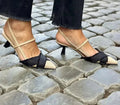 Women's apricot and black colour block pointed-toe stiletto sandals with a buckle strap.