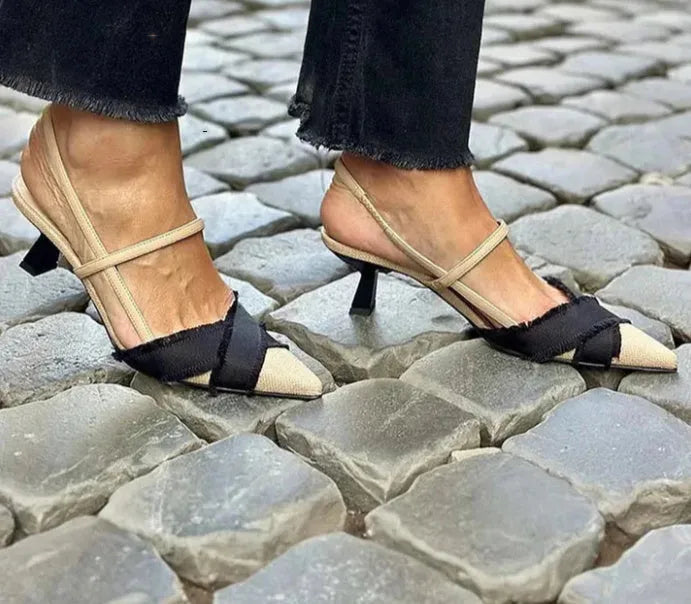 Women's apricot and black colour block pointed-toe stiletto sandals with a buckle strap.
