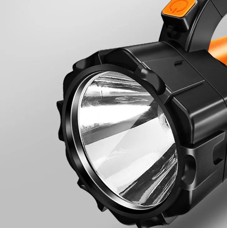 H771 portable handheld searchlight with shoulder strap, shown in an outdoor setting.