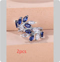 Adjustable copper ring with a detailed leaf design and zircon accents in various colour options.