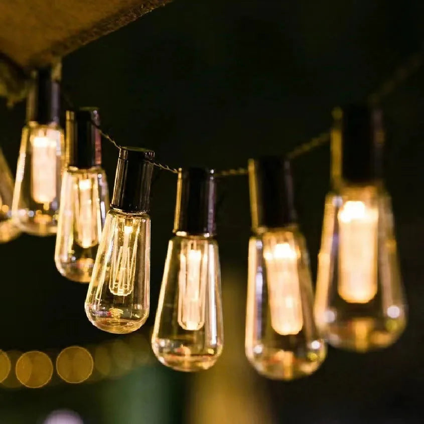 Solar powered outdoor string lights with retro long bulb infusion bottle shapes on 10 metre cable