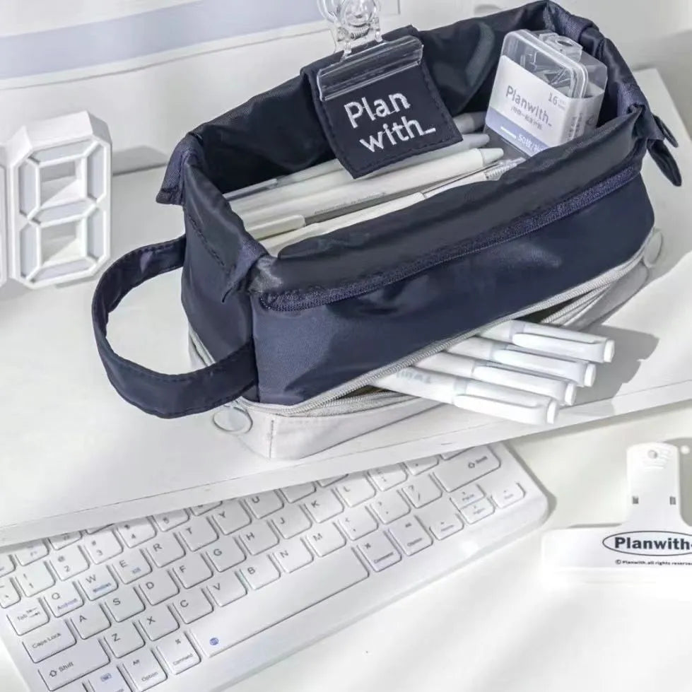 Folding double-layer student pencil case in blue polyester fabric showing internal organisation compartments.