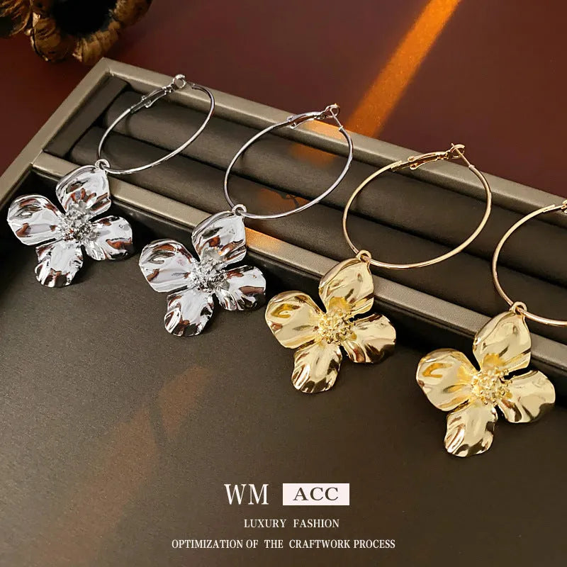 Gold and silver vintage metal flower earrings with geometric design and a silver needle detail.