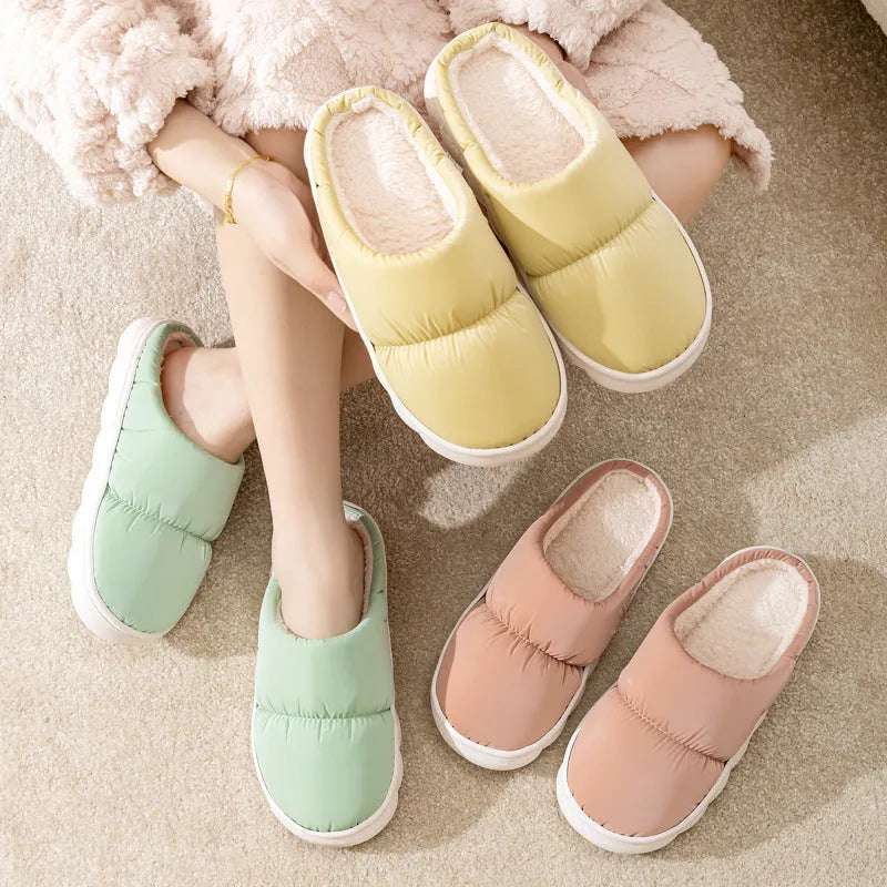 Blue down cotton slippers with thick rubber sole and plush lining, shown from side.