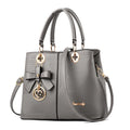 Retro PU handbag with zip closure and shoulder strap in multiple colours.