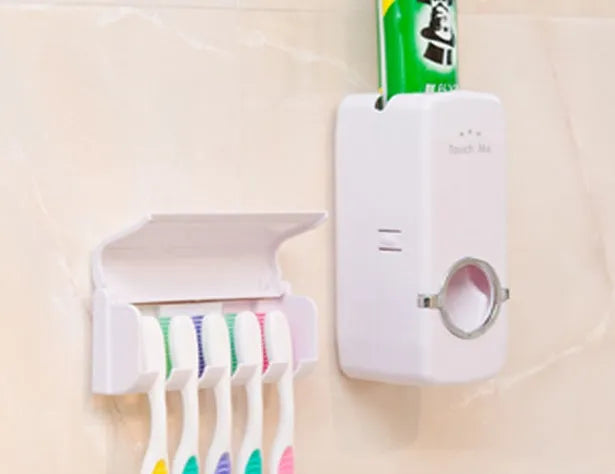 White adhesive wall-mounted toothbrush holder with pump on a bathroom tile.
