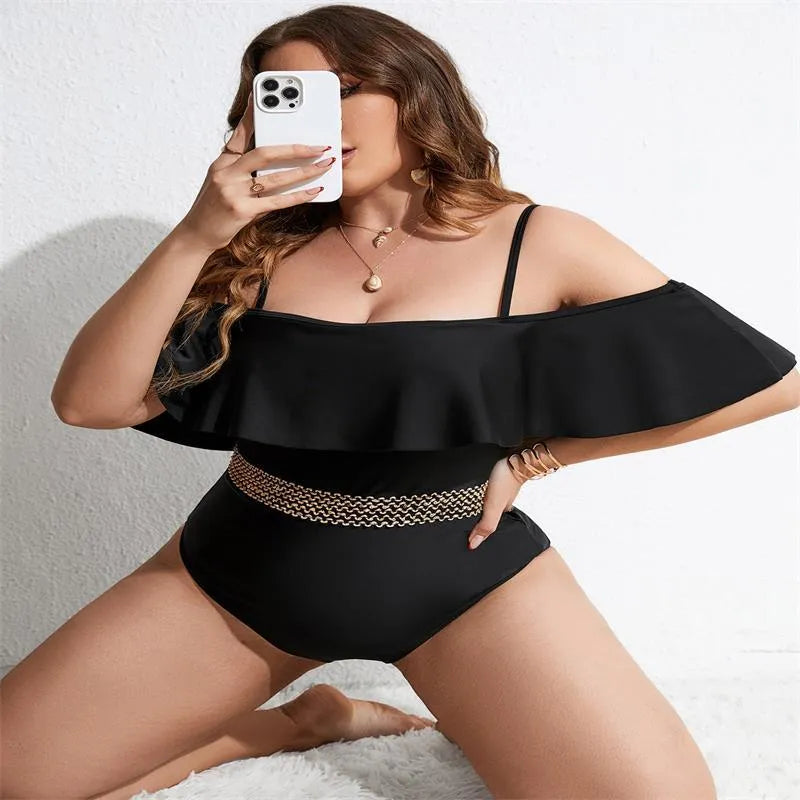 Black solid colour women's one-piece polyester swimsuit on a hanger.