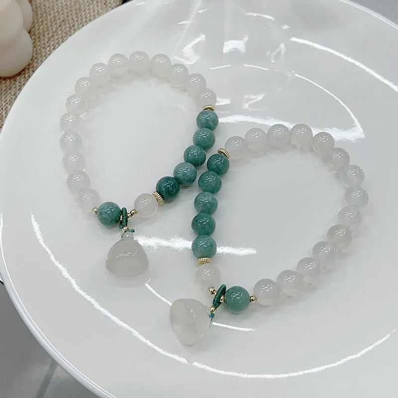 Close-up of a women's retro Chinese style agate lotus seedpod bracelet on an adjustable strap.